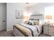 Charming bedroom featuring a decorative bed frame, bedside tables, and carpeted floors at 1007 143Rd Ne St, Bradenton, FL 34212