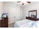 Comfortable bedroom featuring a striped bedspread, ceiling fan, and carpeted floors at 1007 143Rd Ne St, Bradenton, FL 34212