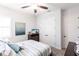 Cozy bedroom featuring a ceiling fan, striped bedspread, and carpeted floors at 1007 143Rd Ne St, Bradenton, FL 34212