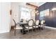 Elegant dining room with a wooden table, stylish chandelier, and wainscotting at 1007 143Rd Ne St, Bradenton, FL 34212