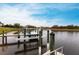 A serene waterfront view featuring sturdy wooden docks, providing direct access to the calm lake waters at 1007 143Rd Ne St, Bradenton, FL 34212