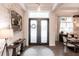 Elegant entryway with dark wood floors, shiplap accent wall, and modern light fixture at 1007 143Rd Ne St, Bradenton, FL 34212