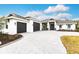Stunning single story home with a three-car garage, brick driveway and tasteful landscaping at 1007 143Rd Ne St, Bradenton, FL 34212
