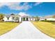 Beautiful single-story home featuring a long brick driveway and meticulously maintained landscaping at 1007 143Rd Ne St, Bradenton, FL 34212