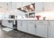 The kitchen features white cabinets, stainless appliances, and modern light fixtures at 1007 143Rd Ne St, Bradenton, FL 34212