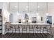Modern kitchen featuring a long quartz counter with six bar stools and pendant lighting at 1007 143Rd Ne St, Bradenton, FL 34212