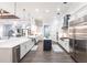 Spacious white kitchen with stainless appliances and a dark island with light fixtures at 1007 143Rd Ne St, Bradenton, FL 34212
