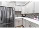 Laundry room features light countertops, stainless steel refrigerator, and mosaic backsplash at 1007 143Rd Ne St, Bradenton, FL 34212