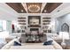 Elegant living room featuring a decorative fireplace, custom shelving, and stylish decor at 1007 143Rd Ne St, Bradenton, FL 34212
