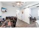 A home office space with hardwood floors, barn-style sliding doors, and a ceiling fan at 1007 143Rd Ne St, Bradenton, FL 34212