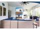 Relaxing screened patio with comfortable wicker seating, outdoor kitchen, and mounted television at 1007 143Rd Ne St, Bradenton, FL 34212