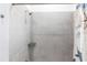 Bathroom shower featuring gray-toned tile walls, a showerhead, and a corner shelf at 1007 143Rd Ne St, Bradenton, FL 34212