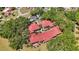 Aerial view of a residential community featuring red tile roofs surrounded by mature trees at 1111 W Faith Cir # 2004, Bradenton, FL 34212