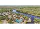 Stunning aerial view of community with a pool and river, surrounded by lush greenery and peaceful scenery at 1111 W Faith Cir # 2004, Bradenton, FL 34212