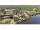 Scenic aerial view of a community with a pool, lake, and lush green landscape at 1111 W Faith Cir # 2004, Bradenton, FL 34212