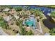 Aerial view showcasing a resort-style pool area nestled amidst lush greenery near a tranquil river at 1111 W Faith Cir # 2004, Bradenton, FL 34212