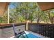 Balcony with chair and shade cover looking out to mature trees and greenery at 1111 W Faith Cir # 2004, Bradenton, FL 34212