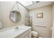 Bright bathroom features a stylish round mirror, white vanity, and decorative beach-themed accents at 1111 W Faith Cir # 2004, Bradenton, FL 34212