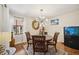 Cozy dining room featuring a chandelier, dark wood table with seating for four, and a sunny window at 1111 W Faith Cir # 2004, Bradenton, FL 34212
