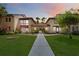 Charming condo exterior featuring lush landscaping, tiled roofs, and a welcoming walkway at dusk at 1111 W Faith Cir # 2004, Bradenton, FL 34212