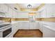 Clean kitchen featuring laminate countertops, white cabinetry, and modern appliances at 1111 W Faith Cir # 2004, Bradenton, FL 34212