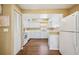 Bright kitchen with white cabinetry and appliances, providing ample storage and workspace at 1111 W Faith Cir # 2004, Bradenton, FL 34212
