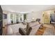 Bright living room with large windows, neutral decor, hardwood flooring, and comfortable seating arrangement at 1111 W Faith Cir # 2004, Bradenton, FL 34212