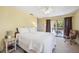 Bright main bedroom with a ceiling fan, carpeted floors and access to a private balcony at 1111 W Faith Cir # 2004, Bradenton, FL 34212