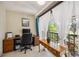 Comfortable office space featuring a desk, chair, and a balcony overlooking a lush outdoor scene at 1111 W Faith Cir # 2004, Bradenton, FL 34212
