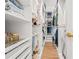 Walk-in closet with built-in shelving and wood flooring at 1189 Fraser Pine Blvd, Sarasota, FL 34240
