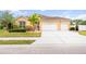 Beautiful one-story home featuring a well-manicured lawn, tiled roof, and a spacious driveway at 1189 Fraser Pine Blvd, Sarasota, FL 34240