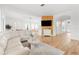 Bright living room featuring a large sectional sofa, decorative wood wall, and open floor plan at 1189 Fraser Pine Blvd, Sarasota, FL 34240