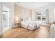 Main bedroom with hardwood floors, neutral color palette, and an en-suite bathroom at 1189 Fraser Pine Blvd, Sarasota, FL 34240
