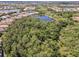 Picturesque aerial view of a residential community with lush green spaces and a serene lake at 12272 Stuart Dr, Venice, FL 34293