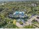 Overhead view of clubhouse featuring a swimming pool, expansive parking, and immaculately landscaped grounds at 12272 Stuart Dr, Venice, FL 34293