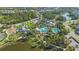 Beautiful aerial view of the community pool, clubhouse, and surrounding landscape at 12272 Stuart Dr, Venice, FL 34293