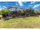 Spacious backyard with a large screened-in patio perfect for outdoor dining and entertaining at 12272 Stuart Dr, Venice, FL 34293