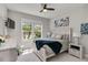 Bright bedroom with a large window, a ceiling fan, and beach themed decor at 12272 Stuart Dr, Venice, FL 34293