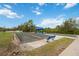 Outdoor bocce ball courts with blue benches and covered seating area at a community recreation area at 12272 Stuart Dr, Venice, FL 34293