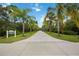 Inviting community entrance features lush landscaping and a welcoming sign for Exploration Park at 12272 Stuart Dr, Venice, FL 34293