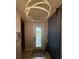 Foyer features a modern light fixture, barn door, and patterned front door at 12272 Stuart Dr, Venice, FL 34293