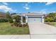 Charming home with a well-manicured lawn, an attached two car garage, and attractive landscaping at 12272 Stuart Dr, Venice, FL 34293