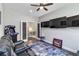 Spacious game room featuring arcade games, comfortable leather seating, and multiple large-screen televisions for entertainment at 12272 Stuart Dr, Venice, FL 34293