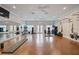 Community gym featuring ceiling fans, mounted TV, yoga mats, and exercise equipment at 12272 Stuart Dr, Venice, FL 34293