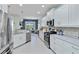 Bright kitchen featuring white cabinets and stainless steel appliances at 12272 Stuart Dr, Venice, FL 34293