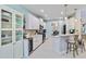 Modern kitchen featuring white cabinets, stainless steel appliances, and a wine cooler at 12272 Stuart Dr, Venice, FL 34293