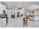 Open kitchen with white cabinetry and a breakfast bar connecting to the living area at 12272 Stuart Dr, Venice, FL 34293