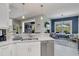 Kitchen featuring white cabinets, an island with bar seating, and backyard views at 12272 Stuart Dr, Venice, FL 34293