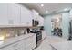 Bright kitchen featuring white cabinets, stainless steel appliances, and plenty of counter space at 12272 Stuart Dr, Venice, FL 34293