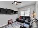Modern living room featuring leather seating, multi-screen display, and accent rug at 12272 Stuart Dr, Venice, FL 34293